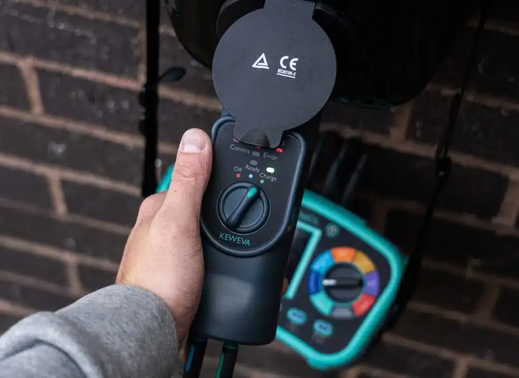 Electrician testing an EV charge point with the KEWEVA